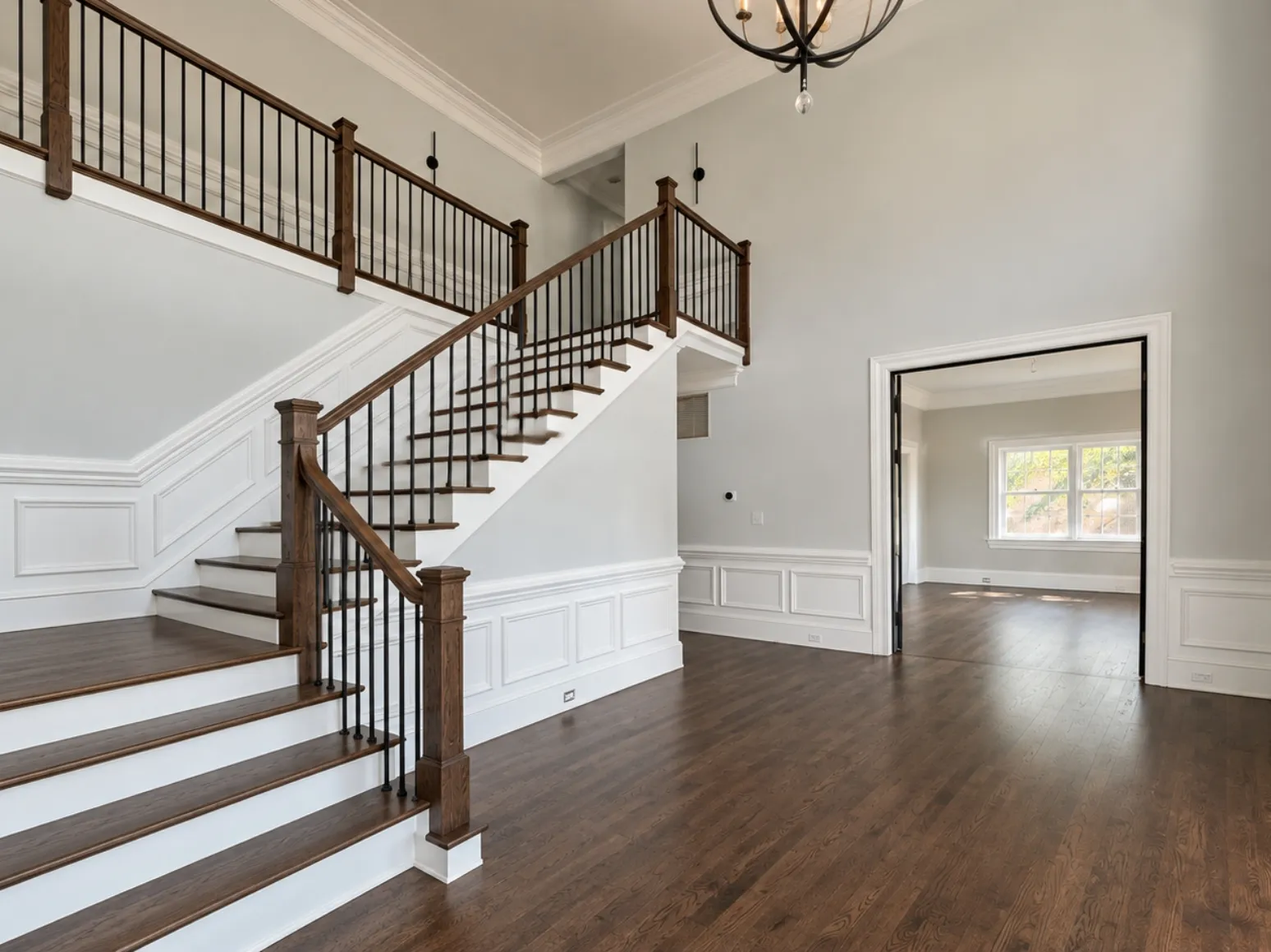 After hardwood installation: Two-story foyer, tile to dark hardwood