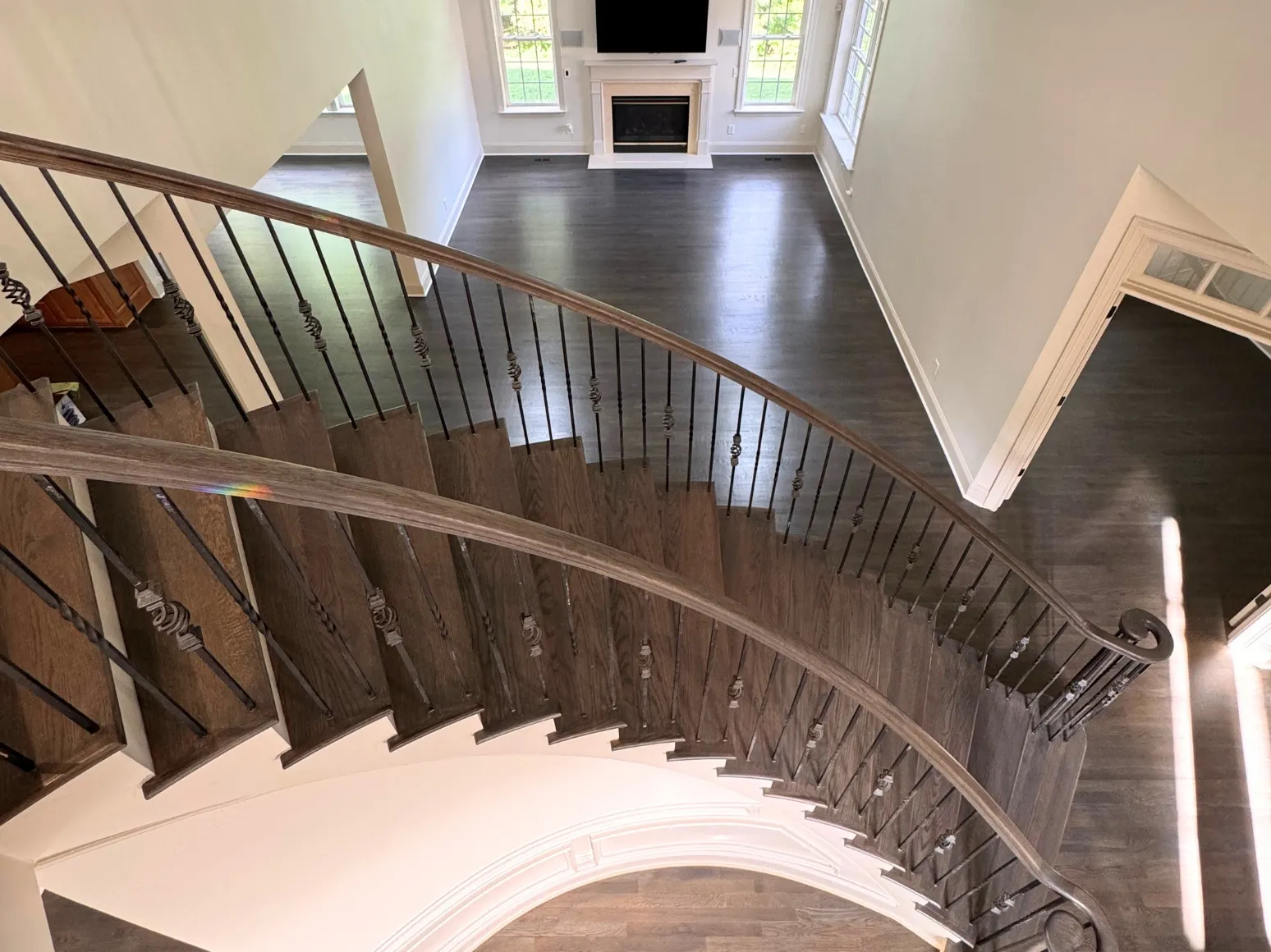 After hardwood installation: Curved staircase and foyer, orange oak to dark brown