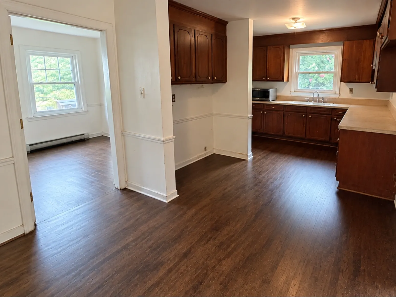 After hardwood installation: Kitchen, old subfloor to dark hardwood