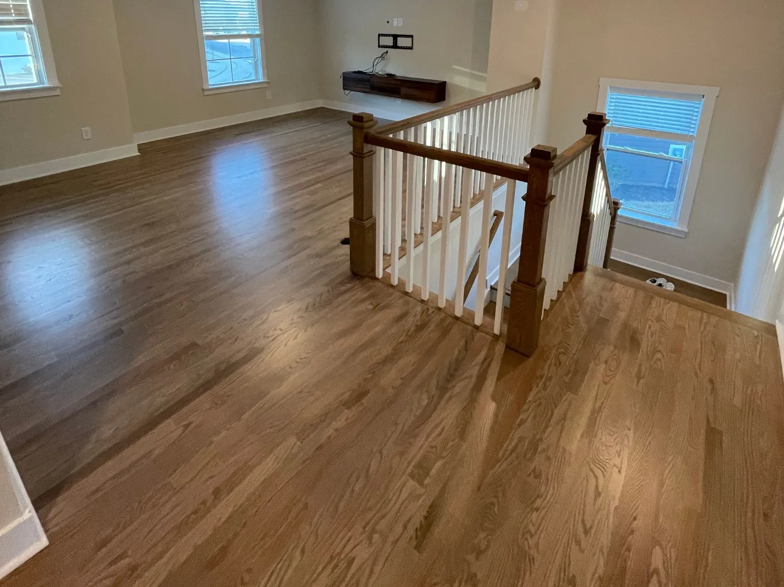 After hardwood installation: Stair landing, carpet to hardwood
