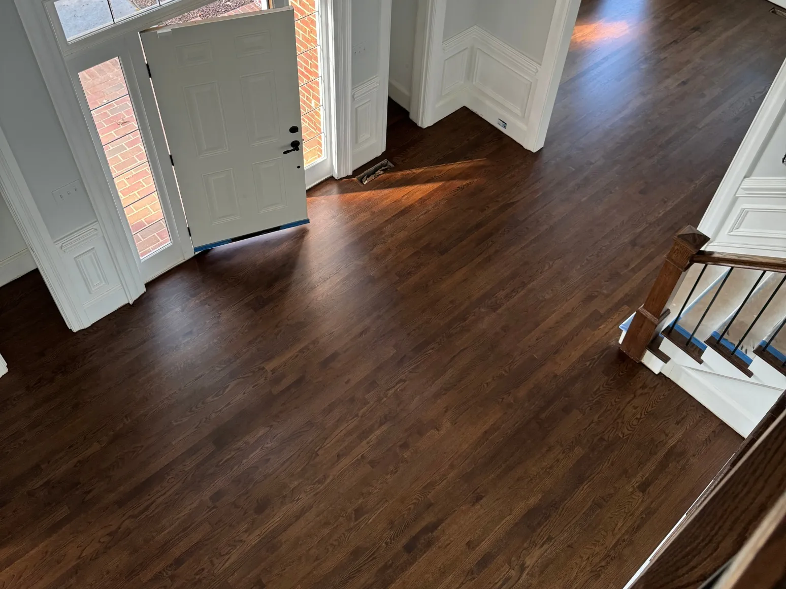 After hardwood installation: Entry, white tile to dark hardwood