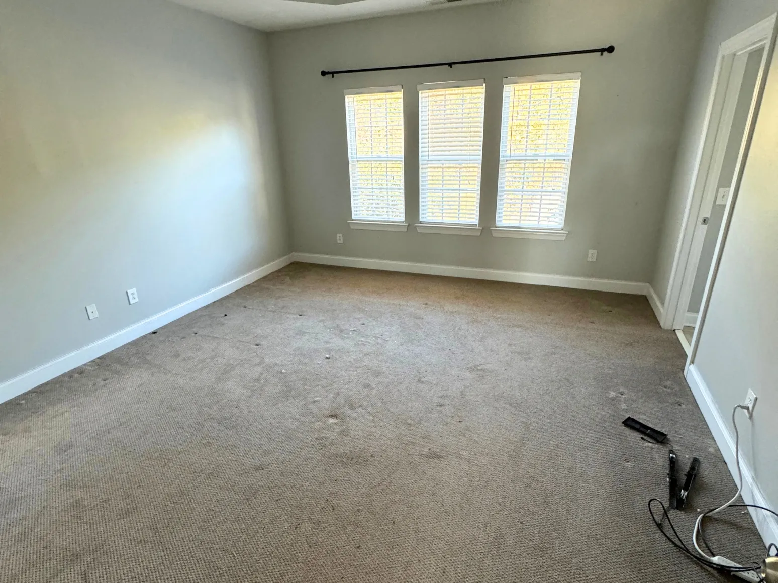 Before hardwood installation: Bedroom, worn carpet to wide-plank hardwood