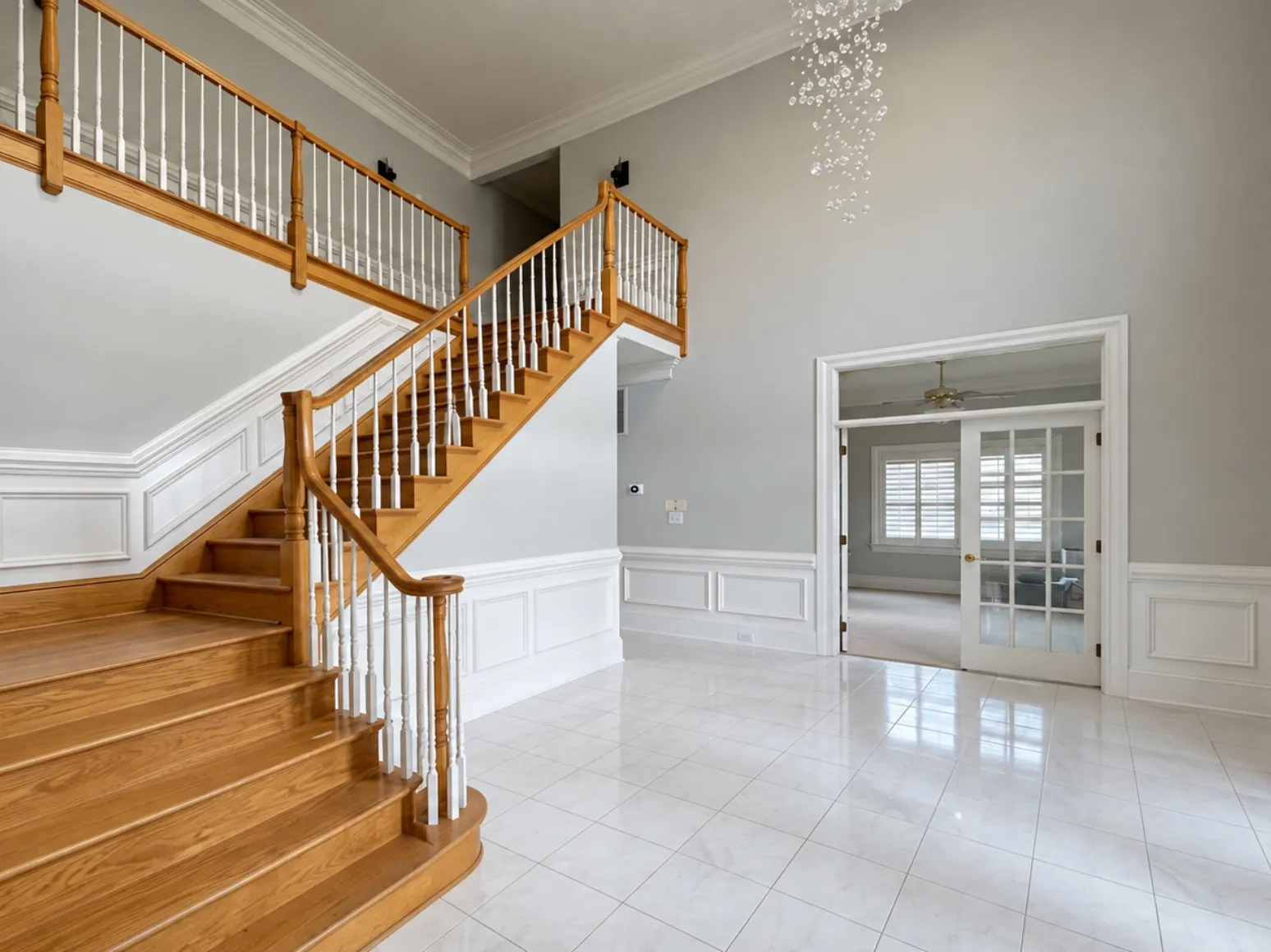Before hardwood installation: Two-story foyer, tile to dark hardwood
