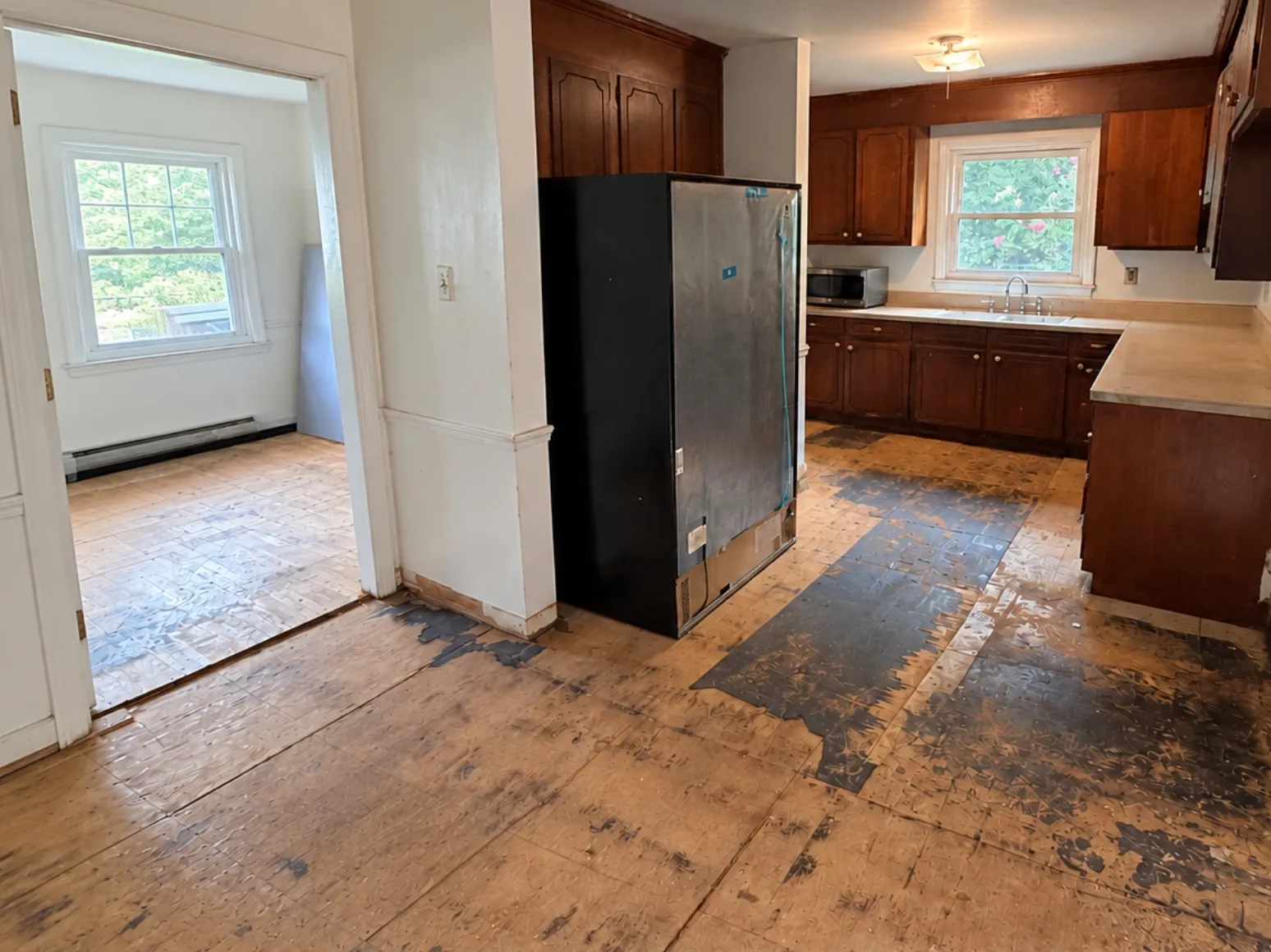 Before hardwood installation: Kitchen, old subfloor to dark hardwood