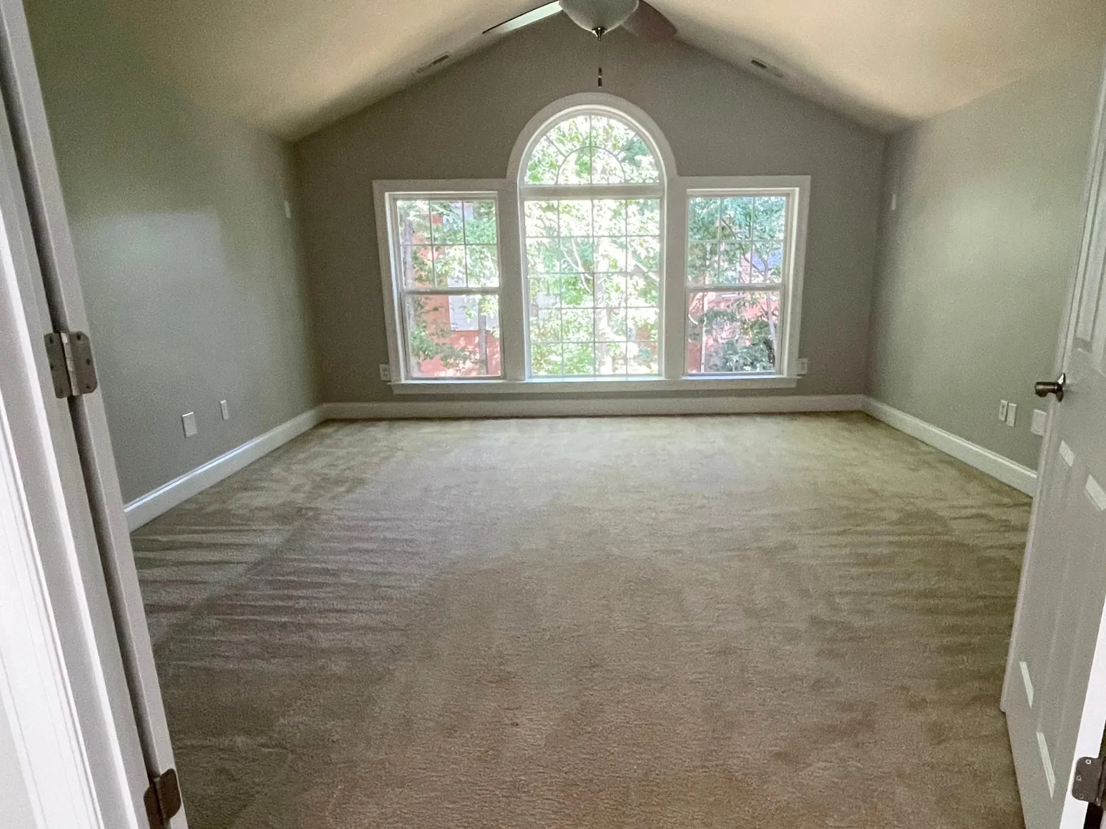 Before hardwood installation: Vaulted bonus room, carpet to dark hardwood