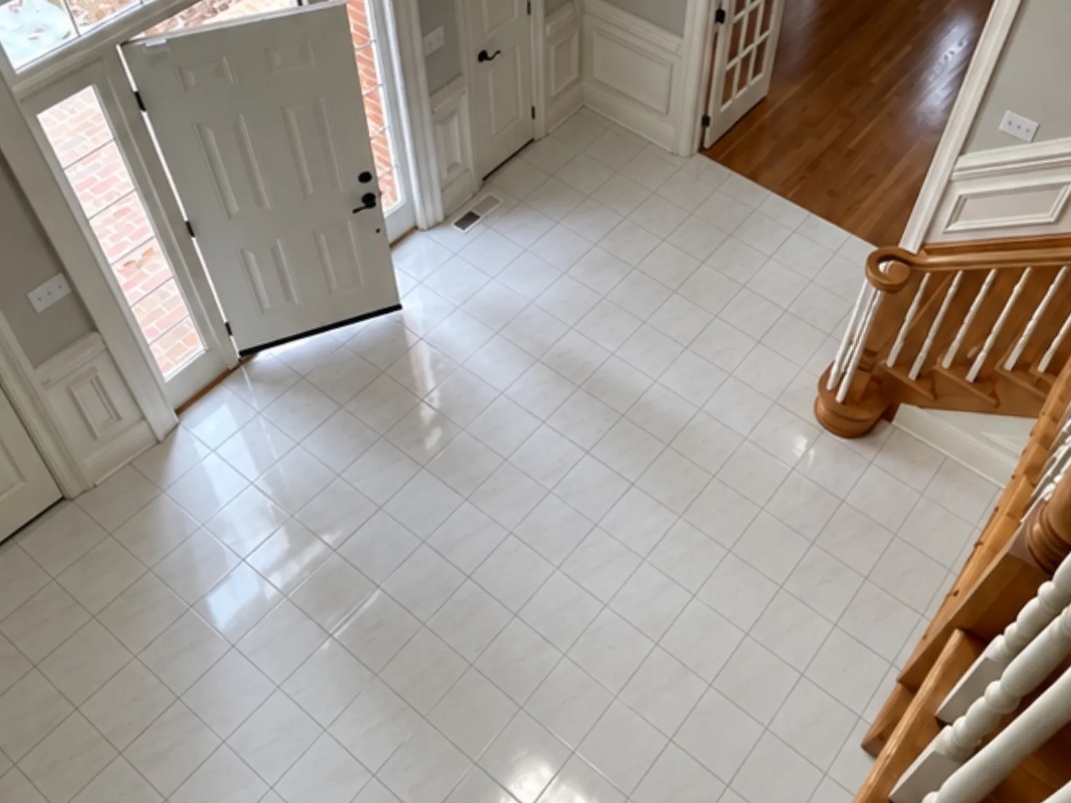 Before hardwood installation: Entry, white tile to dark hardwood