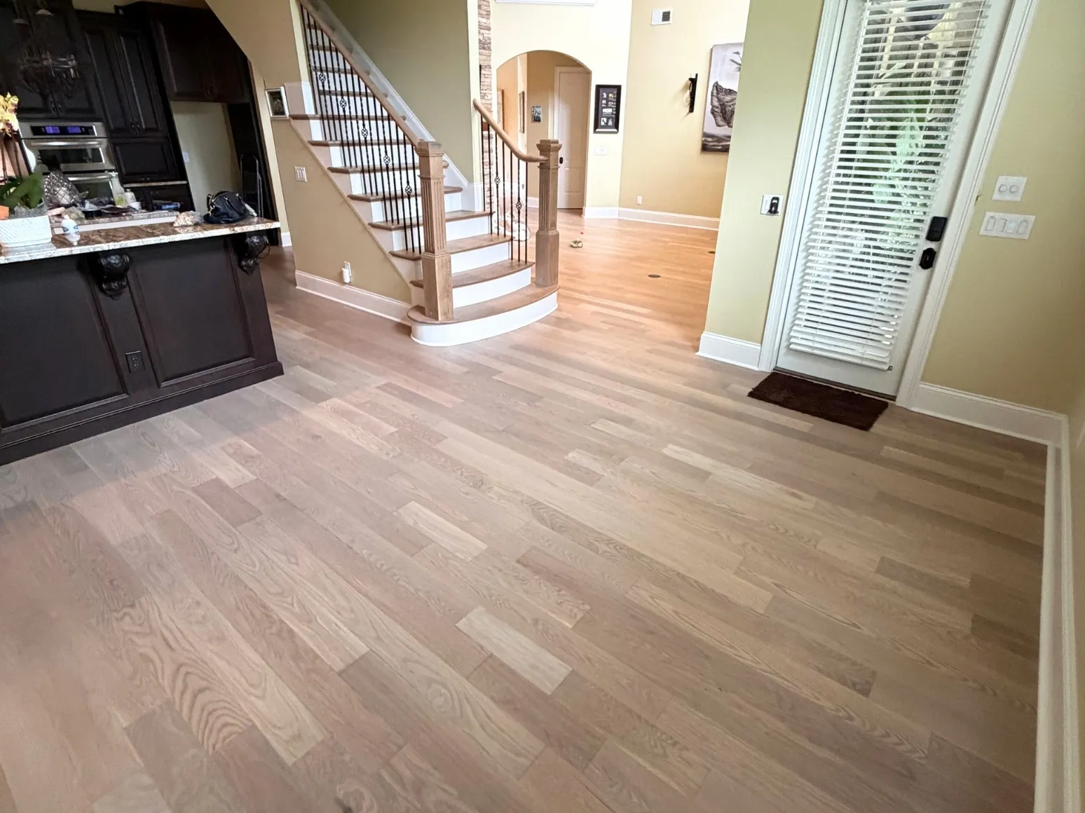 After refinishing: Entry and staircase, warm oak to soft gray wash