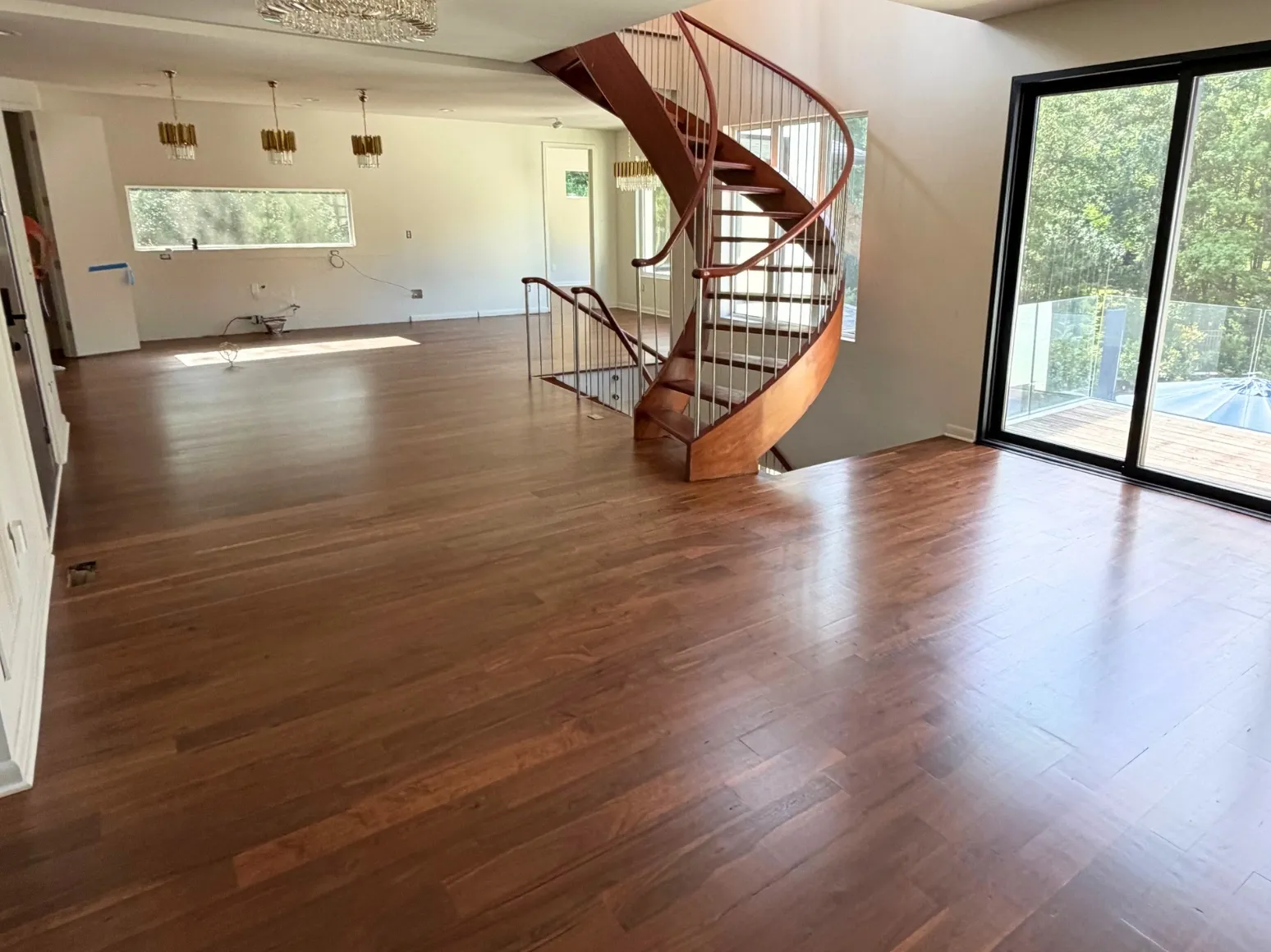 After refinishing: Spiral staircase great room, deeper brown