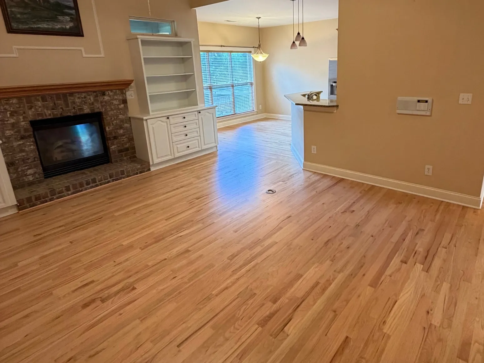 After refinishing: Brick fireplace family room, orange oak to natural