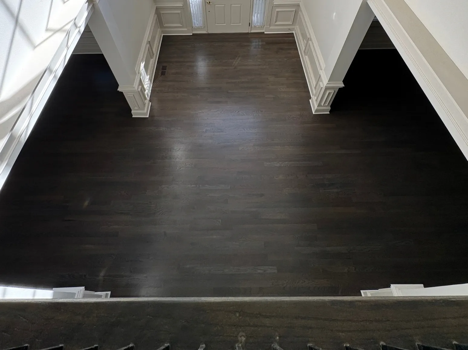 After refinishing: Two-story entry, red-brown to ebony
