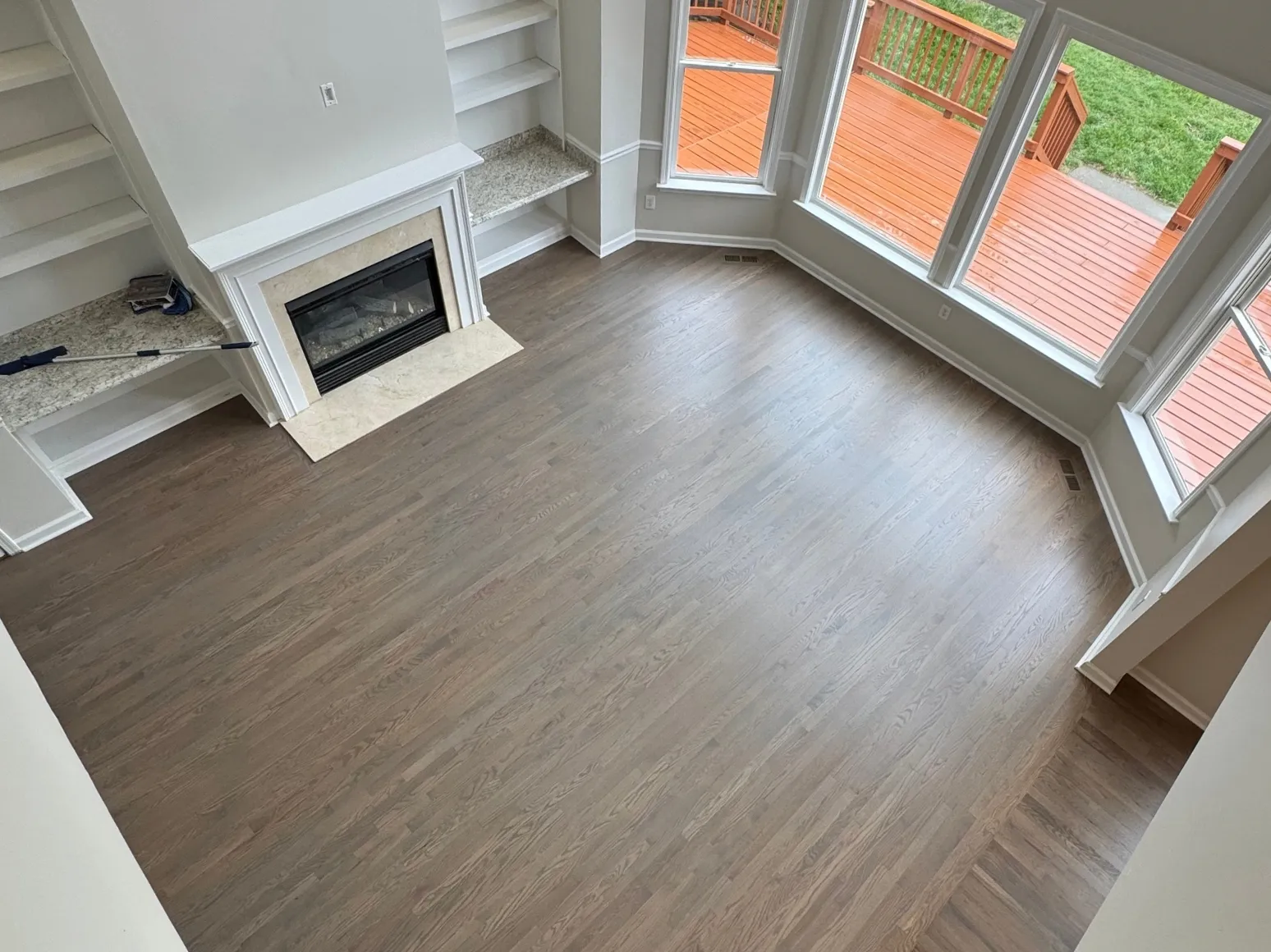 After refinishing: Bay window living room, dark gray-brown