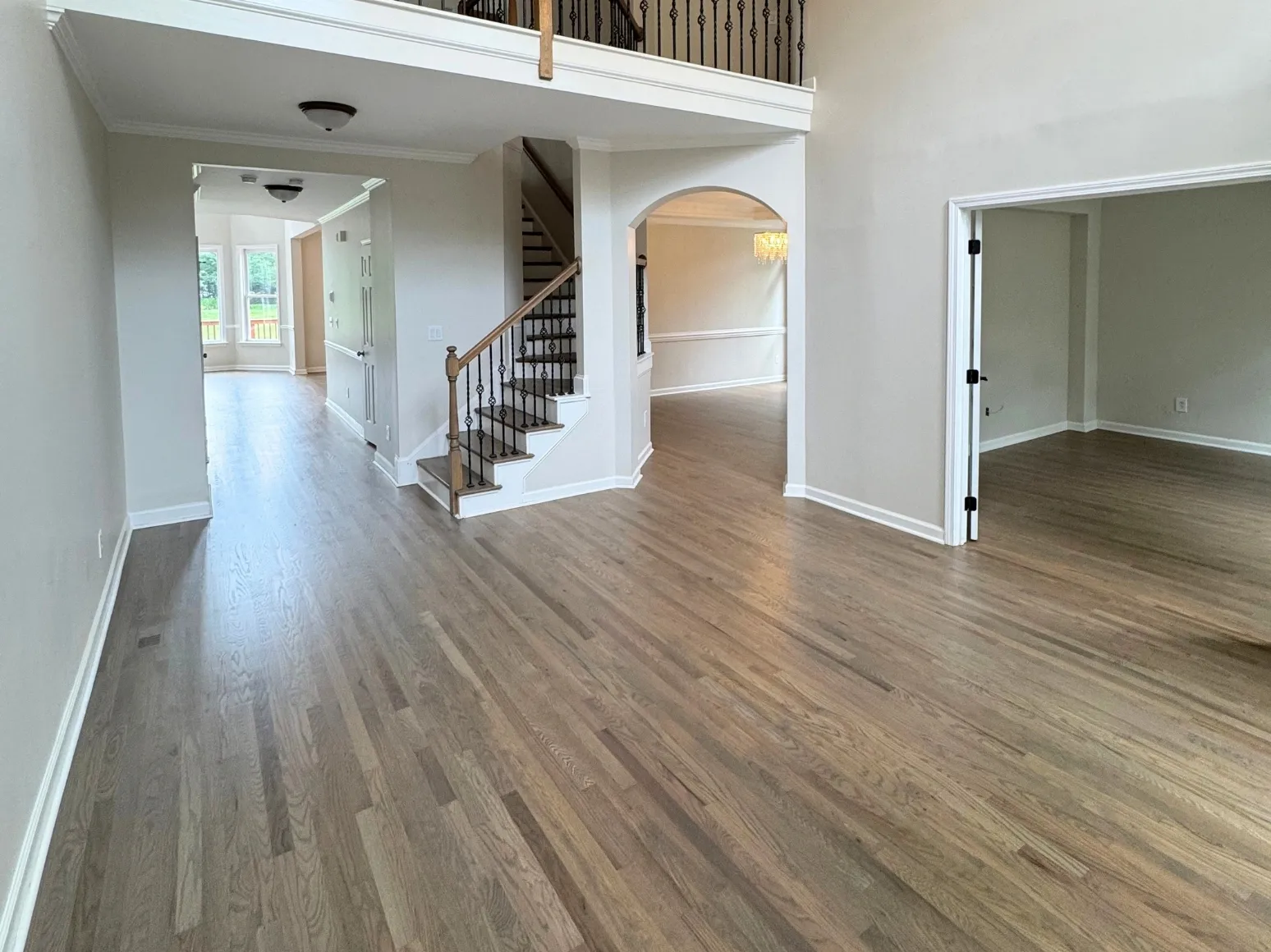 After refinishing: Two-story entry, dark finish to natural gray