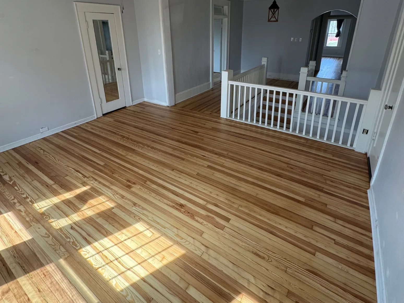 After refinishing: Stairwell landing, sanded to bare oak
