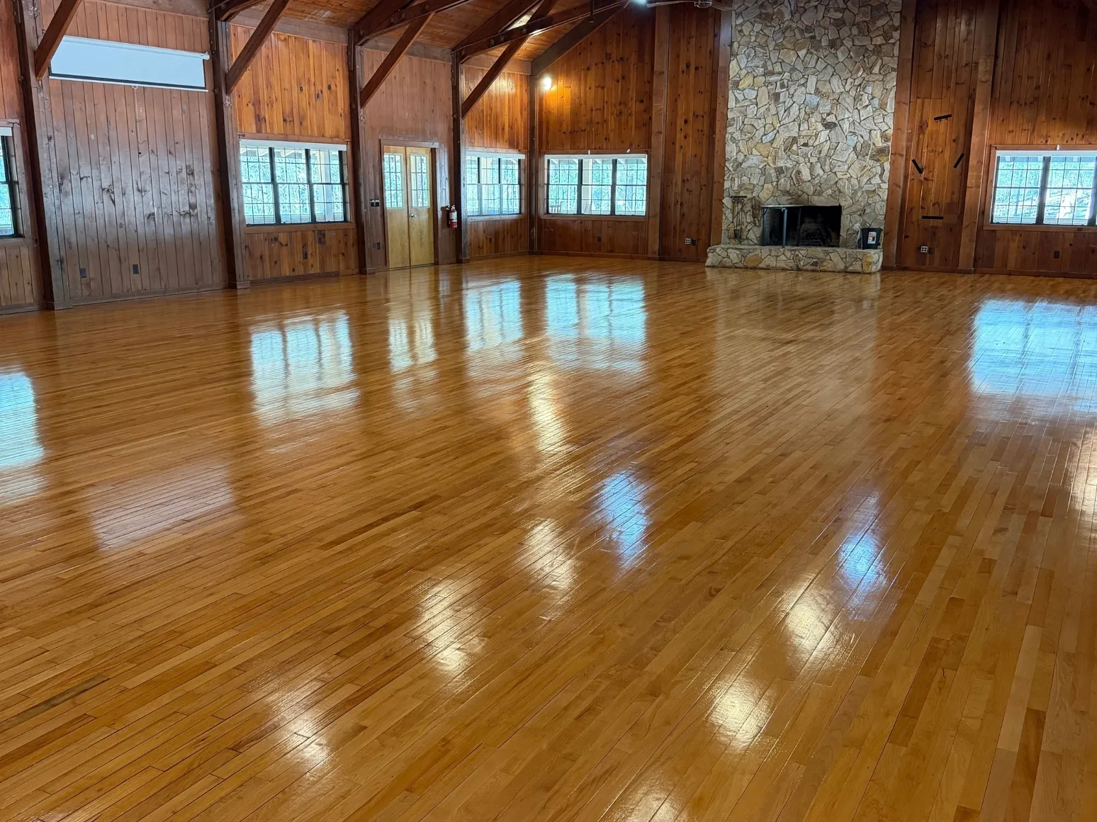After refinishing: Lodge great room, fresh glossy finish