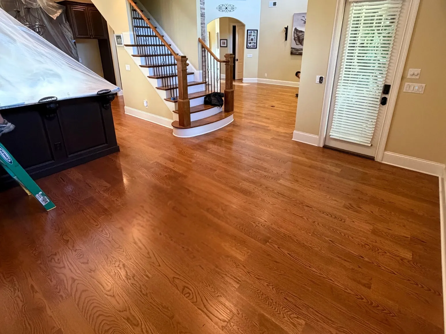 Before refinishing: Entry and staircase, warm oak to soft gray wash