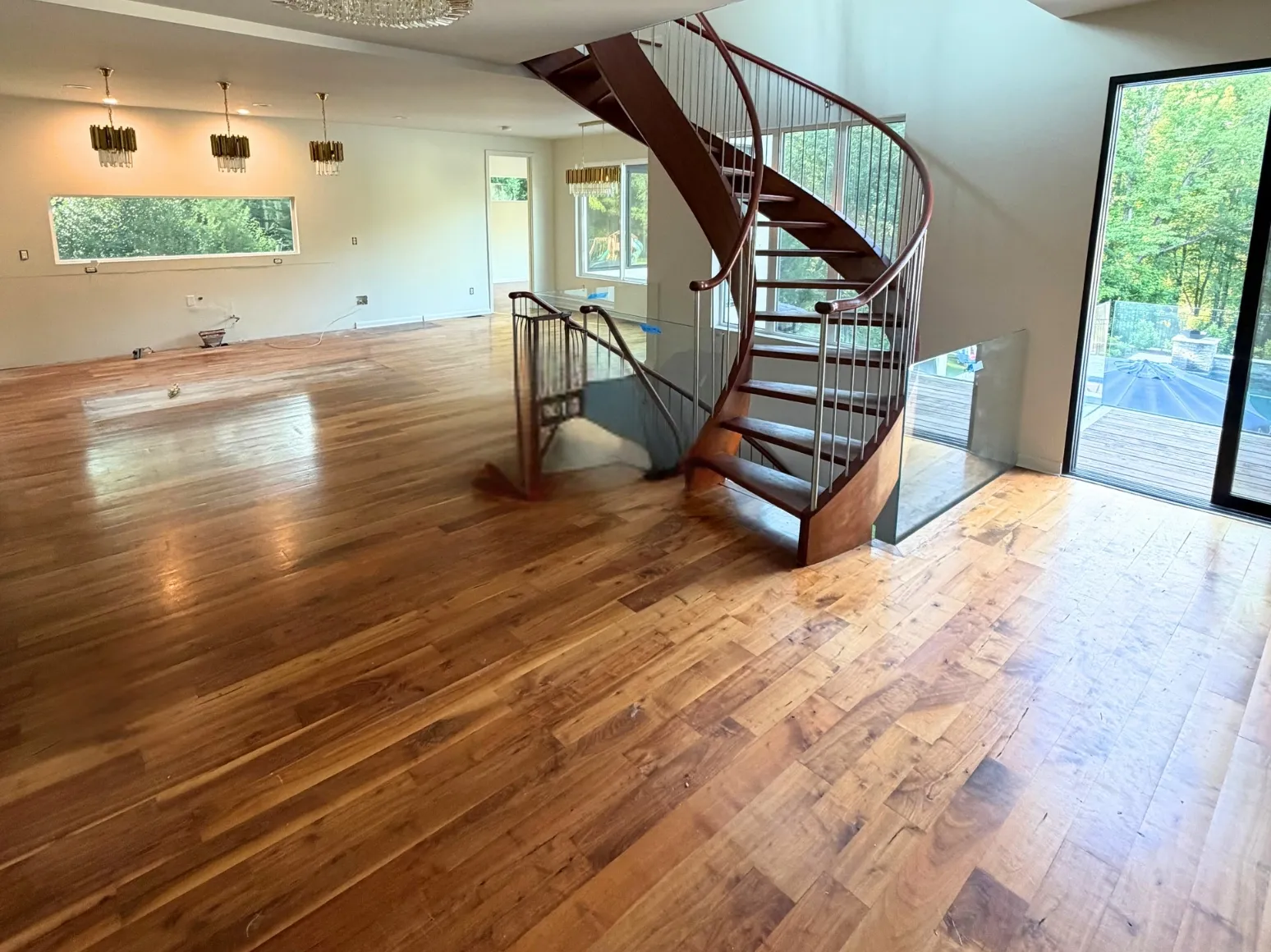 Before refinishing: Spiral staircase great room, deeper brown
