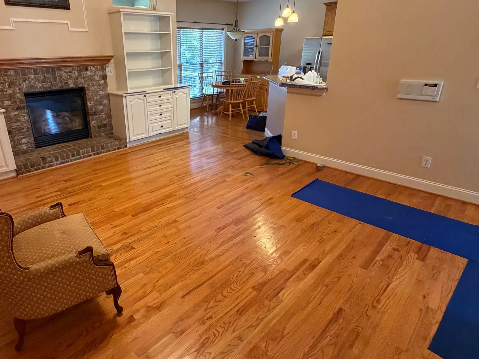 Before refinishing: Brick fireplace family room, orange oak to natural