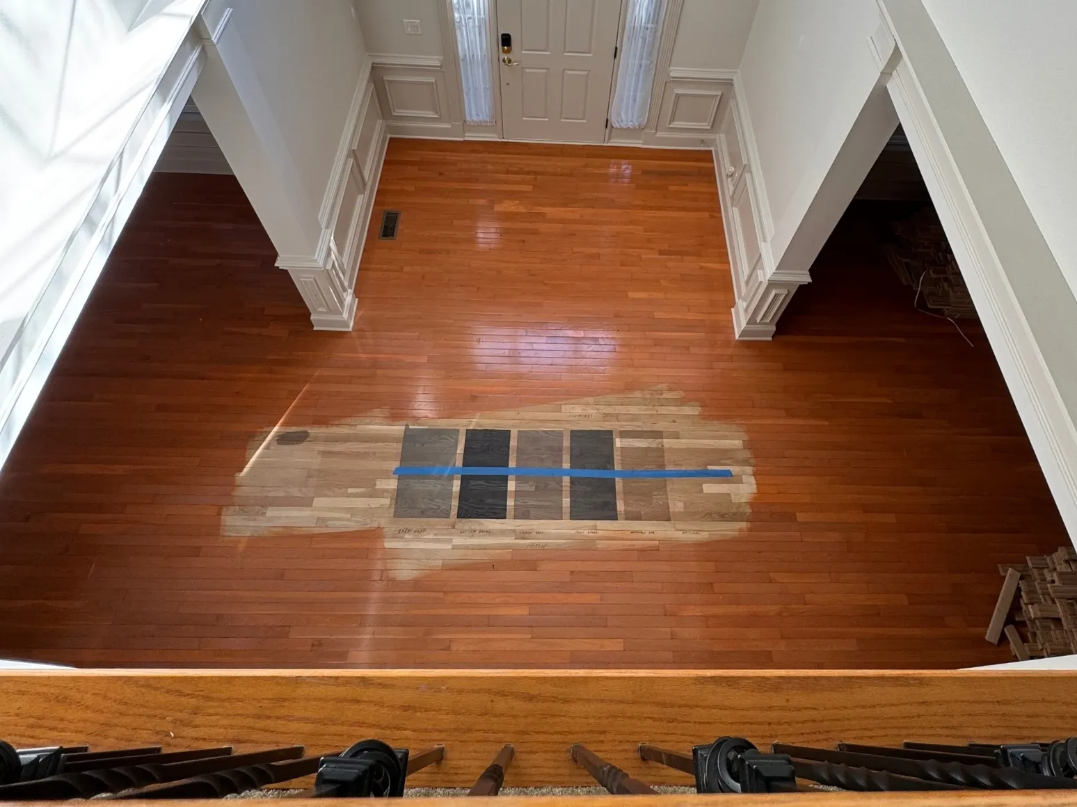 Before refinishing: Two-story entry, red-brown to ebony