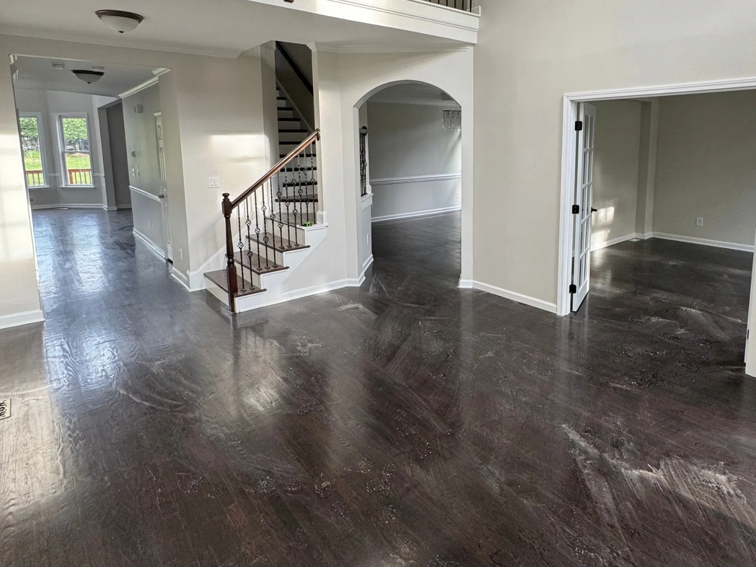 Before refinishing: Two-story entry, dark finish to natural gray
