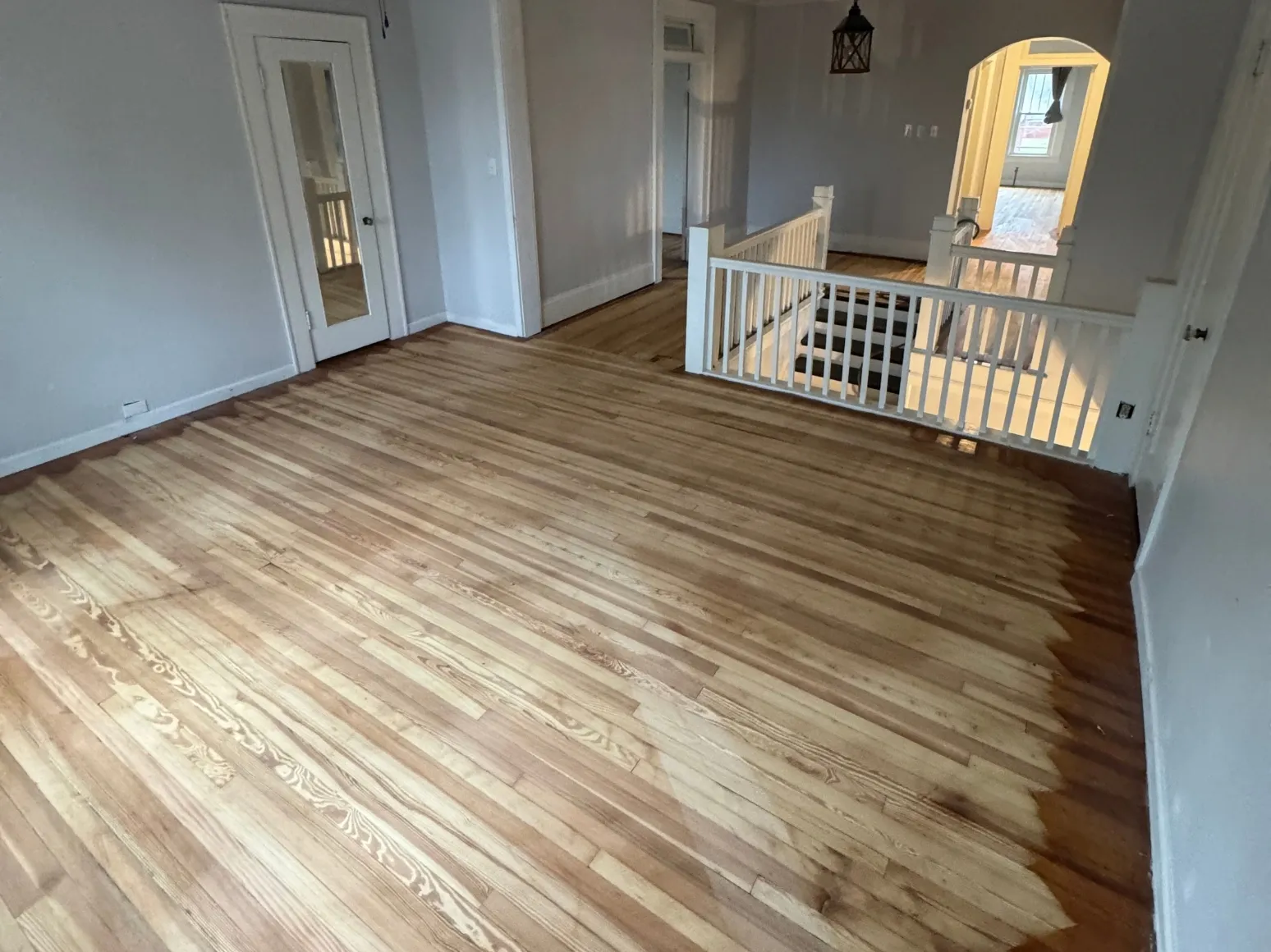 Before refinishing: Stairwell landing, sanded to bare oak