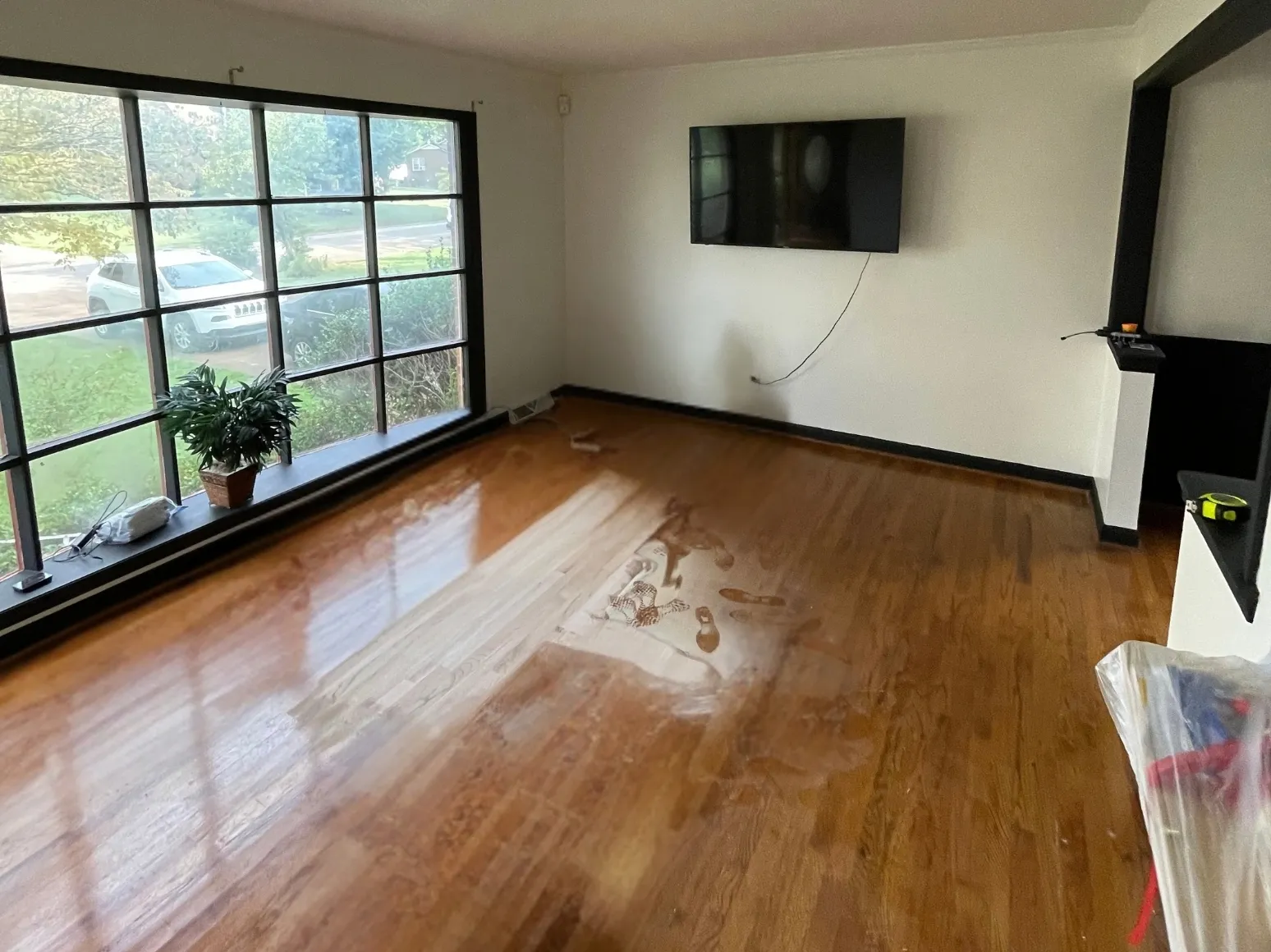 Before refinishing: Sunny living room, sanded to bare oak
