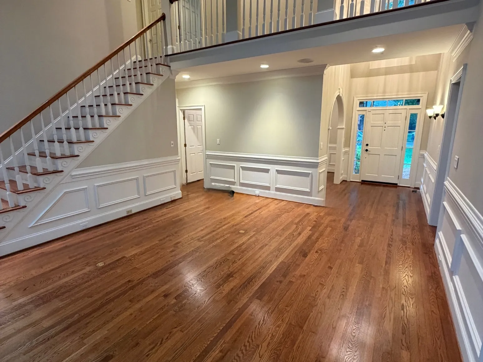Before refinishing: Entry foyer, orange oak to natural
