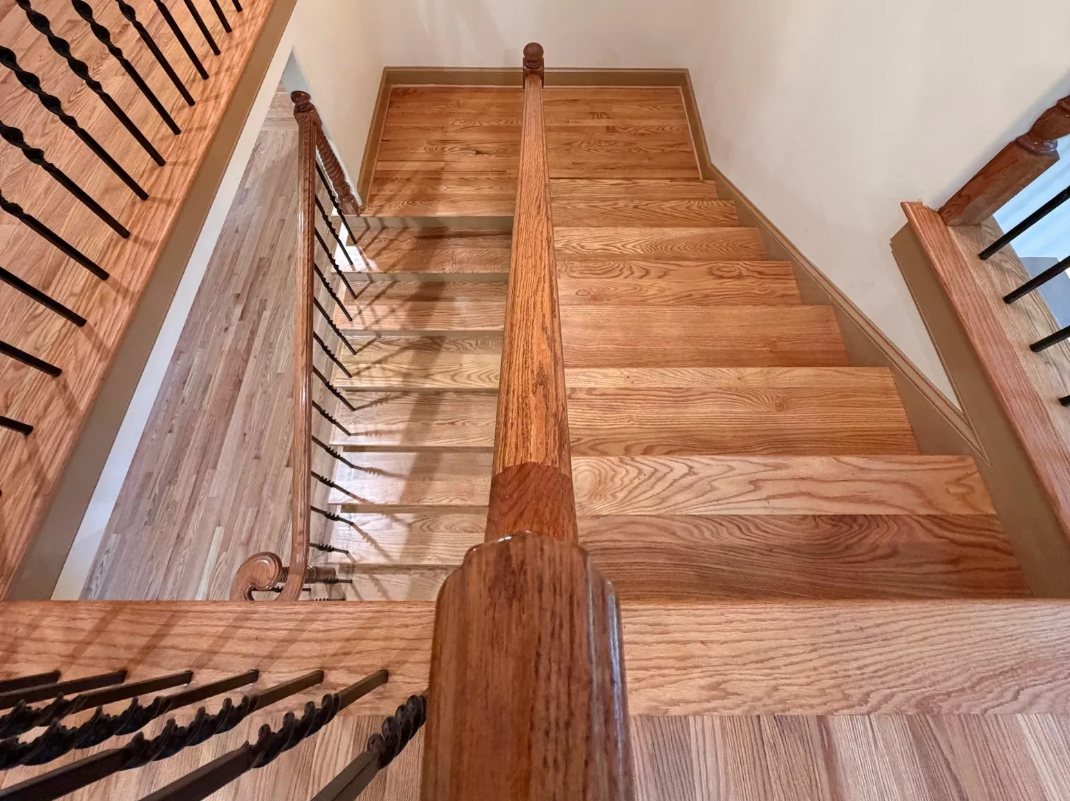 After staircase refinishing: Staircase landing, honey oak refresh
