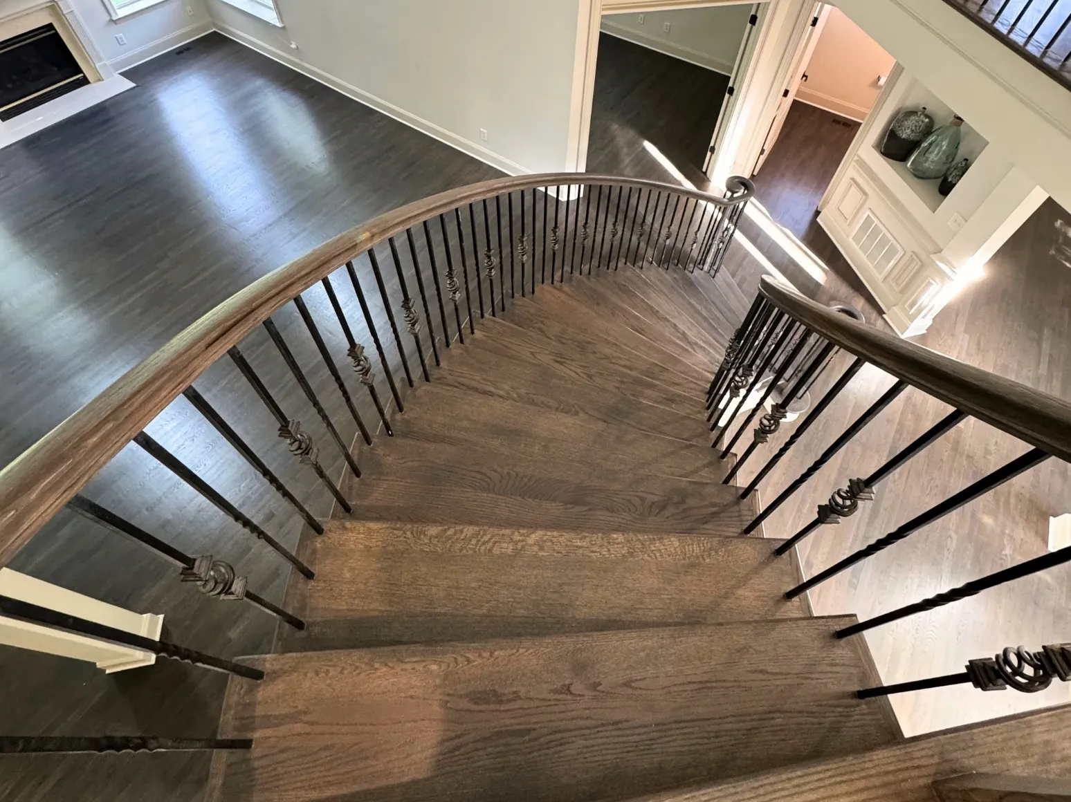 After staircase refinishing: Curved staircase, orange oak to charcoal gray