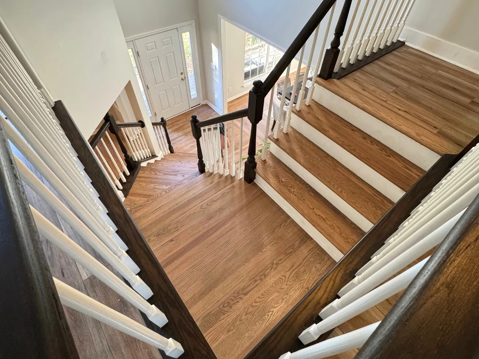After staircase refinishing: Entry staircase, dark handrail and richer treads