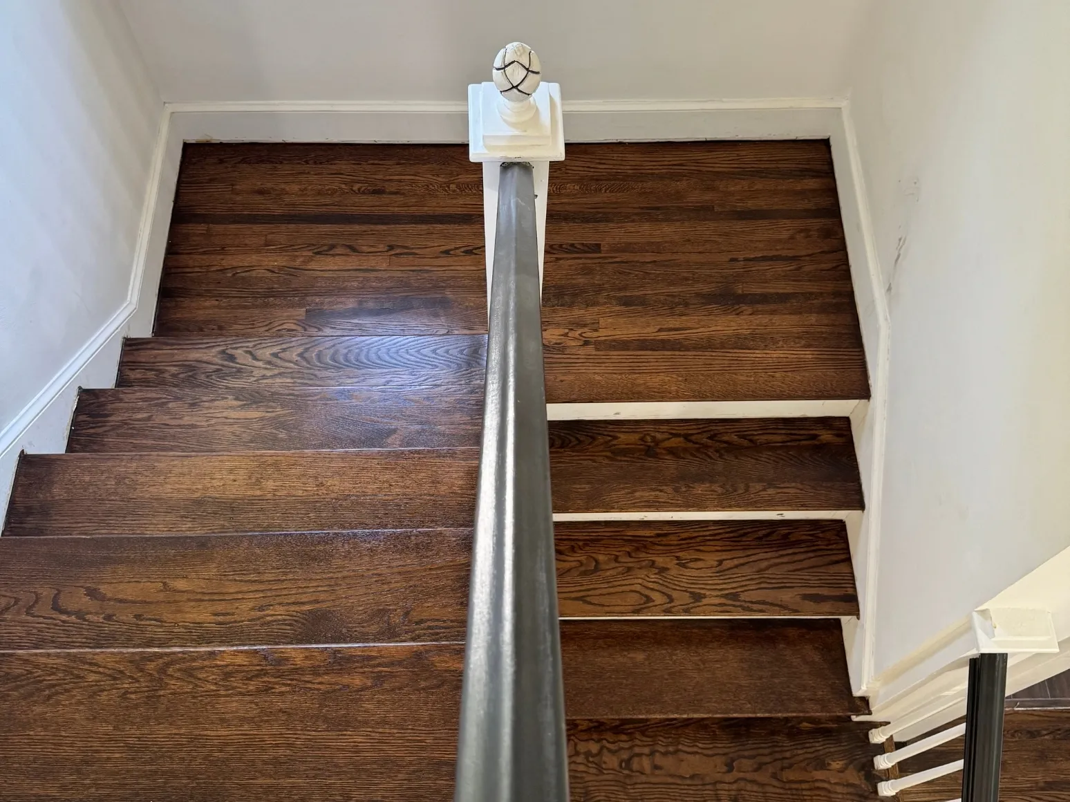 After staircase refinishing: Worn stair treads, restored to rich brown