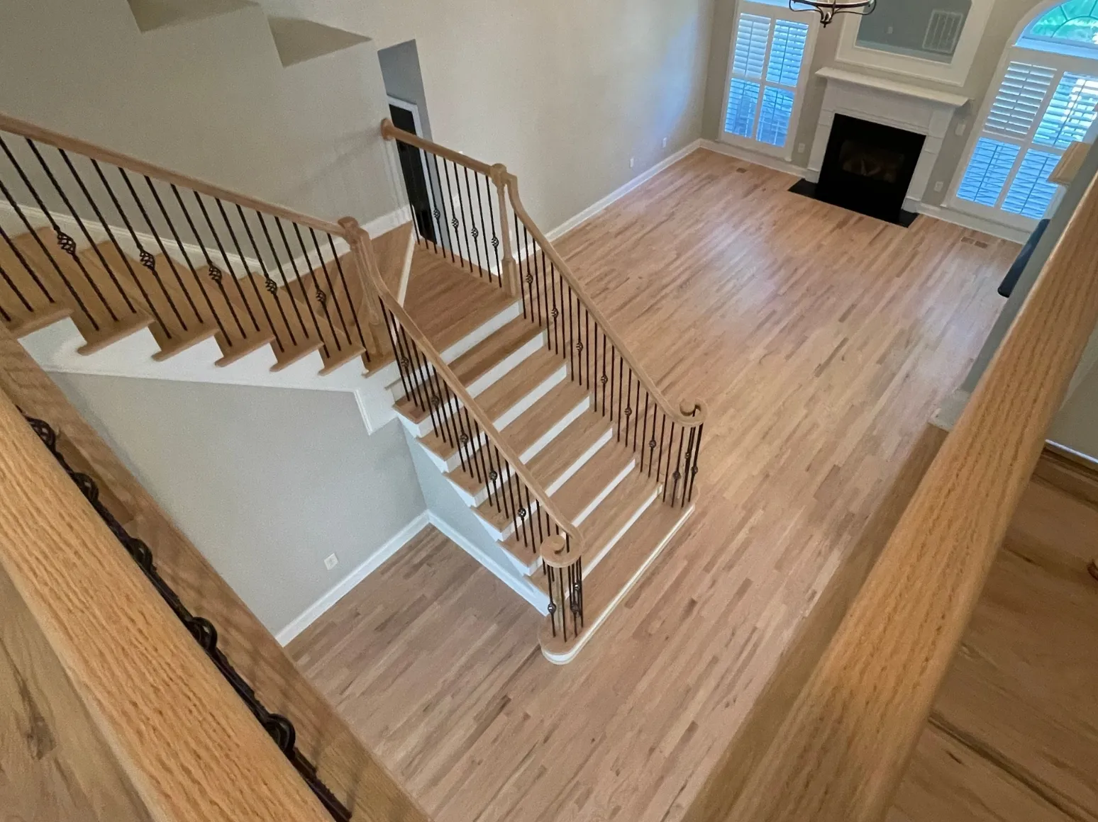 After staircase refinishing: Open staircase and floor, glossy orange to natural