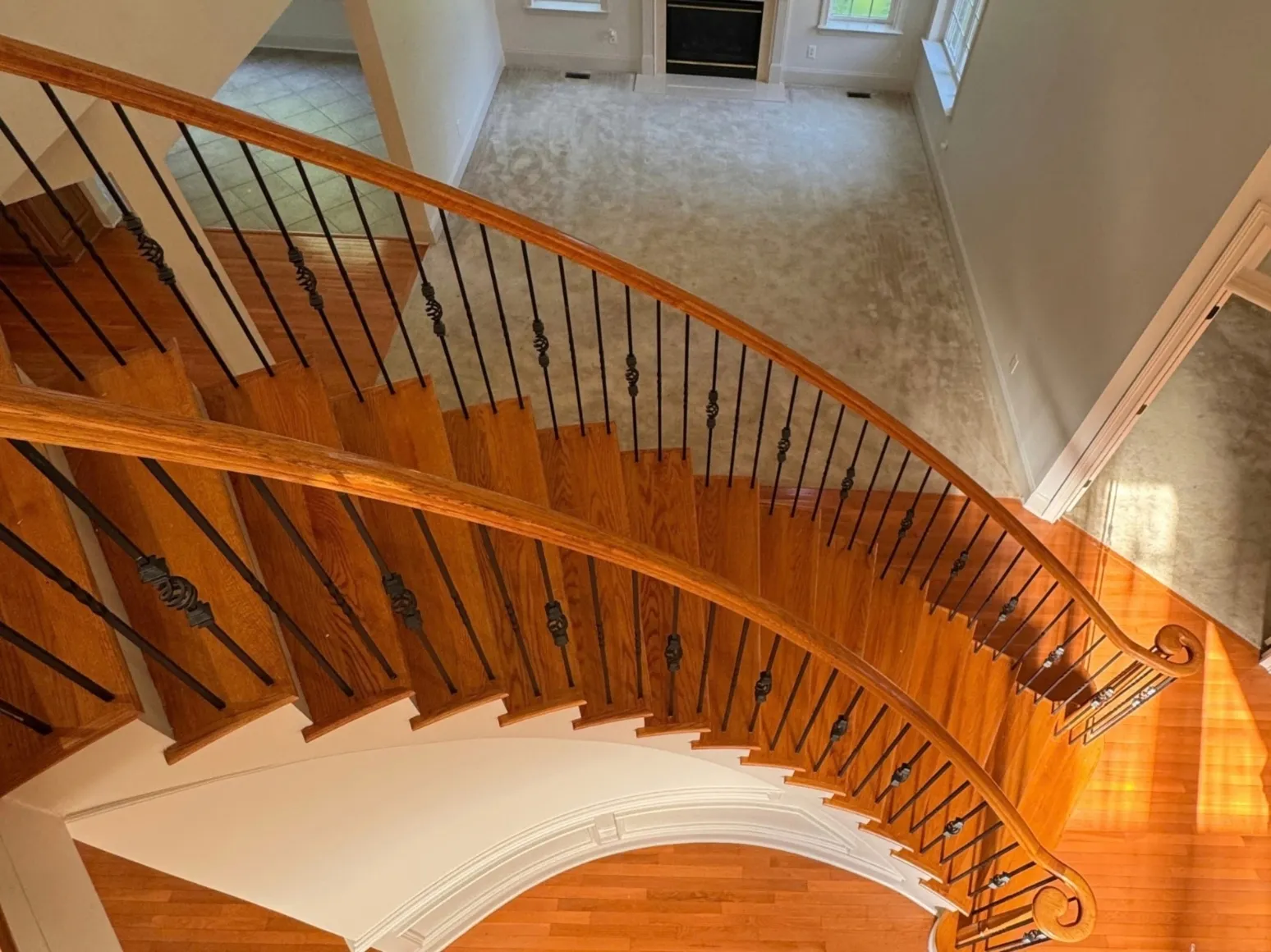 Before staircase refinishing: Curved oak staircase, orange to dark walnut