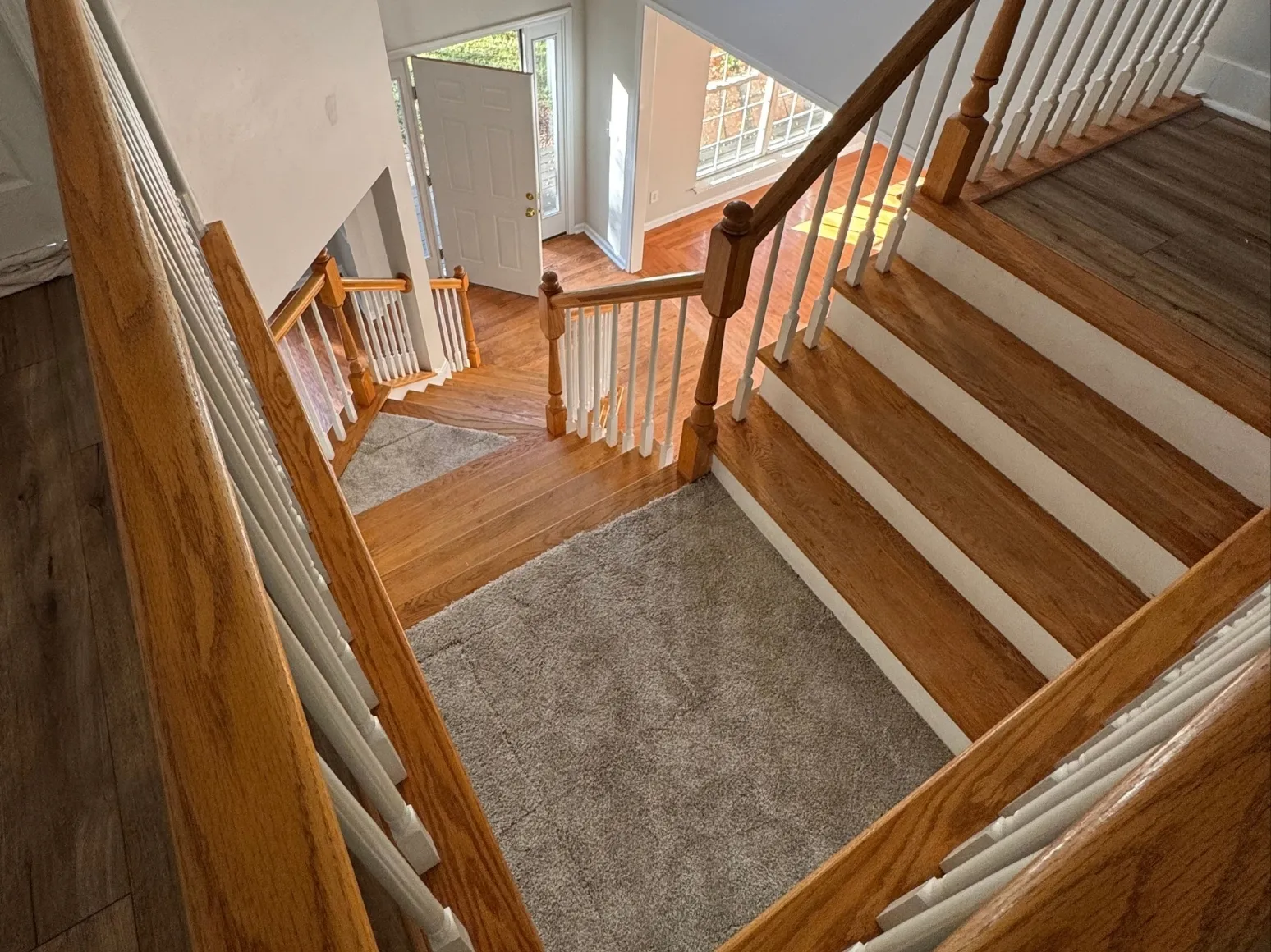 Before staircase refinishing: Entry staircase, dark handrail and richer treads