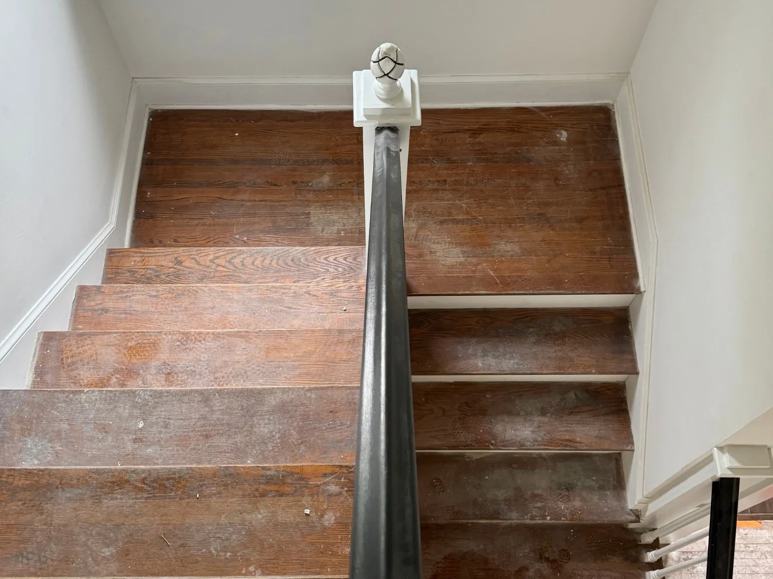 Before staircase refinishing: Worn stair treads, restored to rich brown
