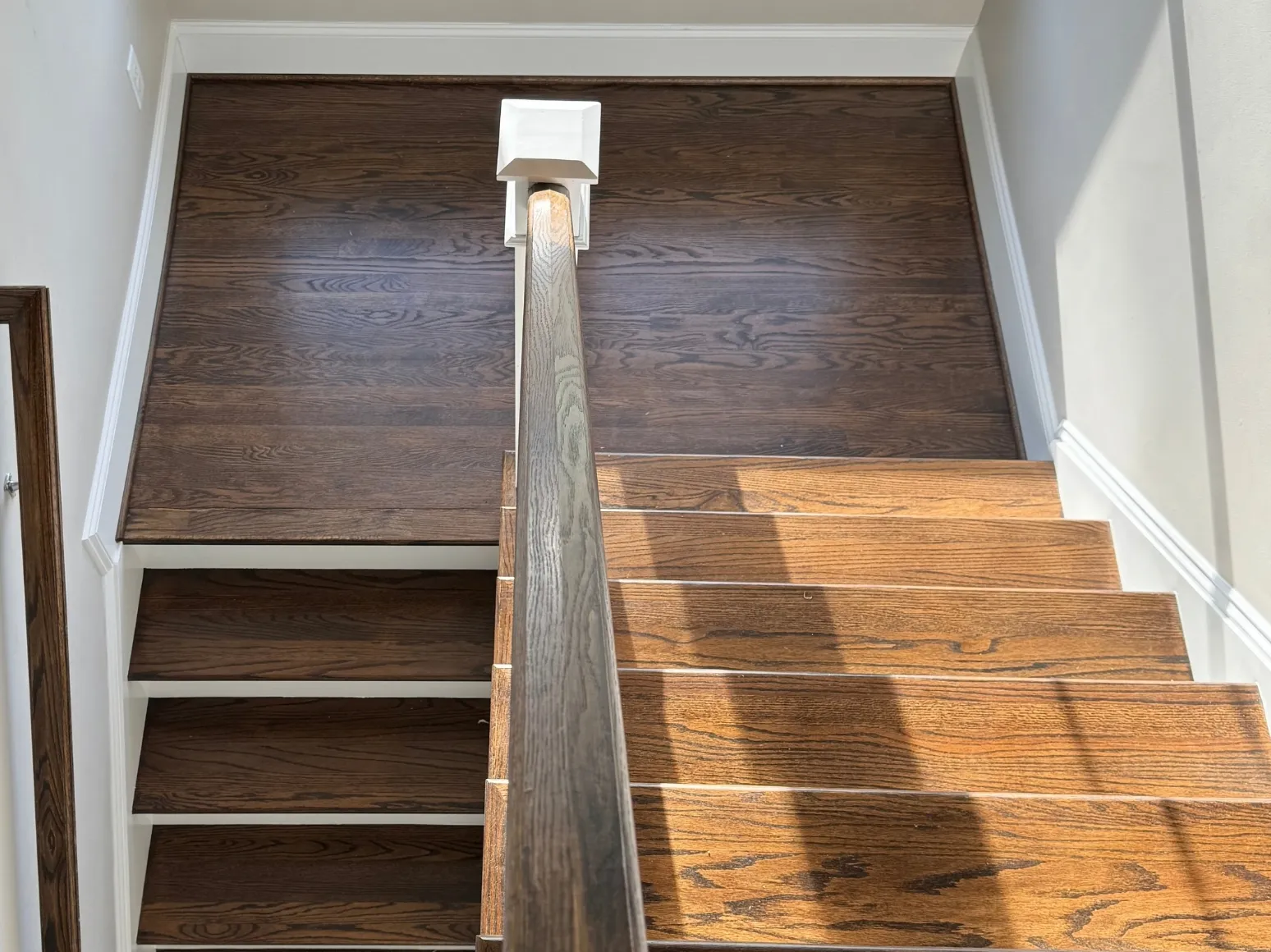 Before staircase refinishing: Stair landing, dark brown to natural oak