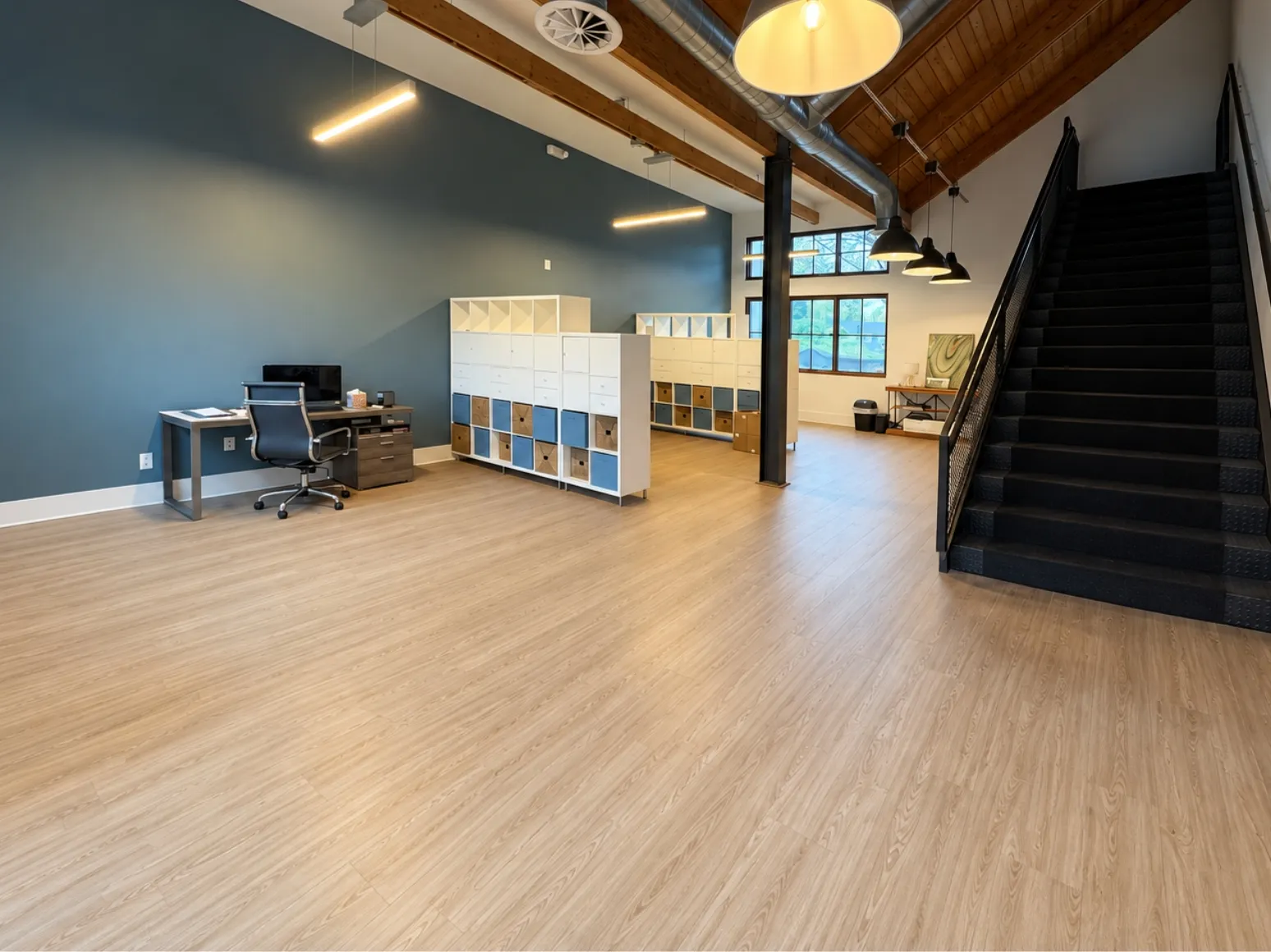 After luxury vinyl plank installation: Open room, dark plank floor to light wood-look vinyl plank