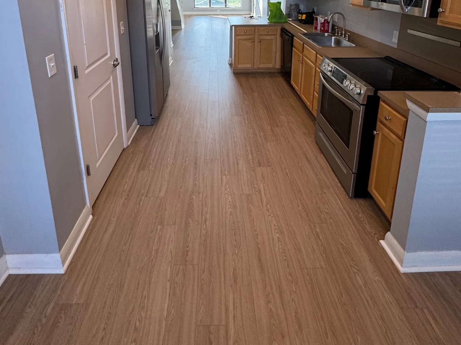 After luxury vinyl plank installation: Kitchen, sheet vinyl to long-plank LVP